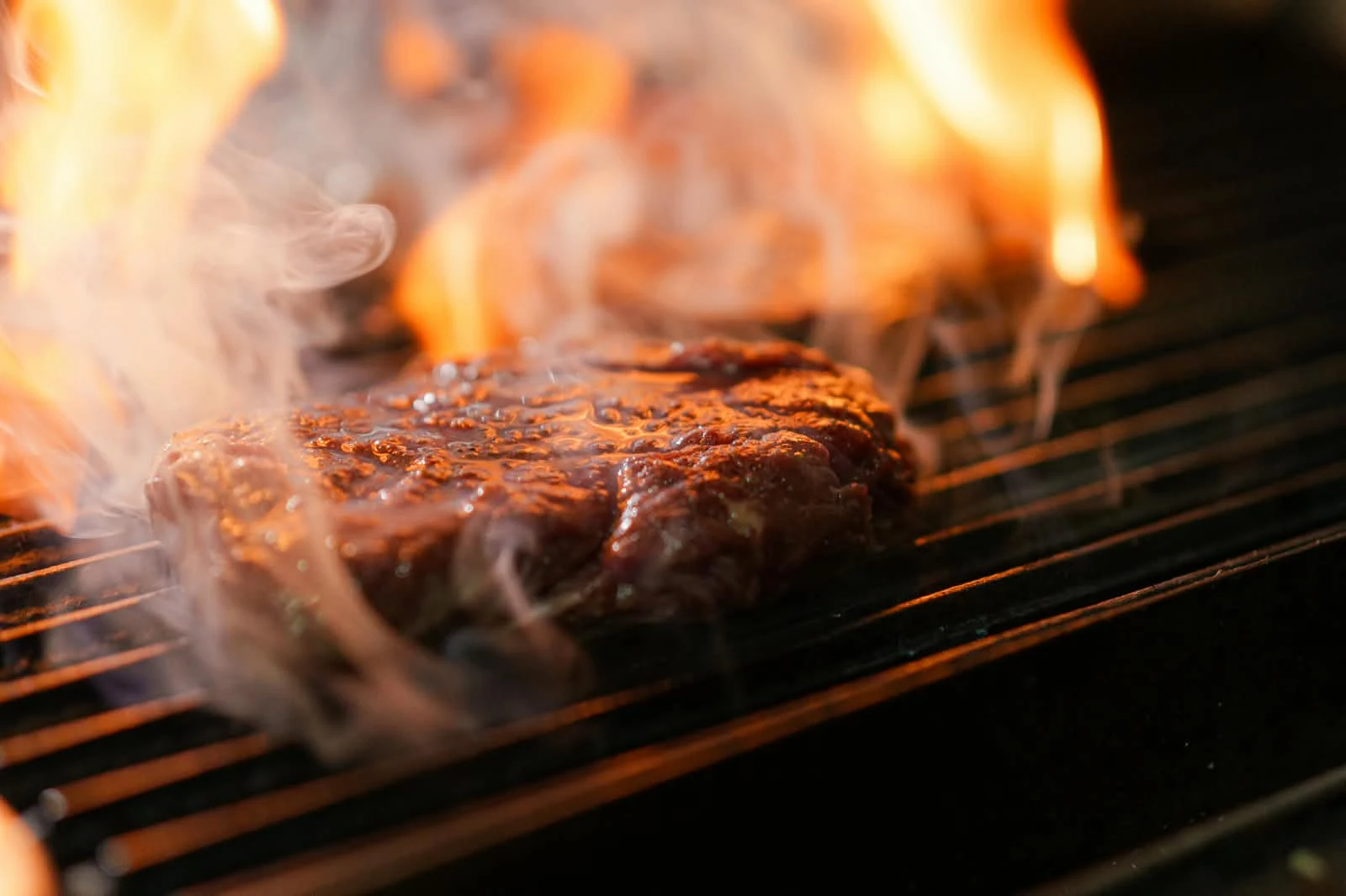 Original steak on flame grill with grilled beef, fries, corn and sauces