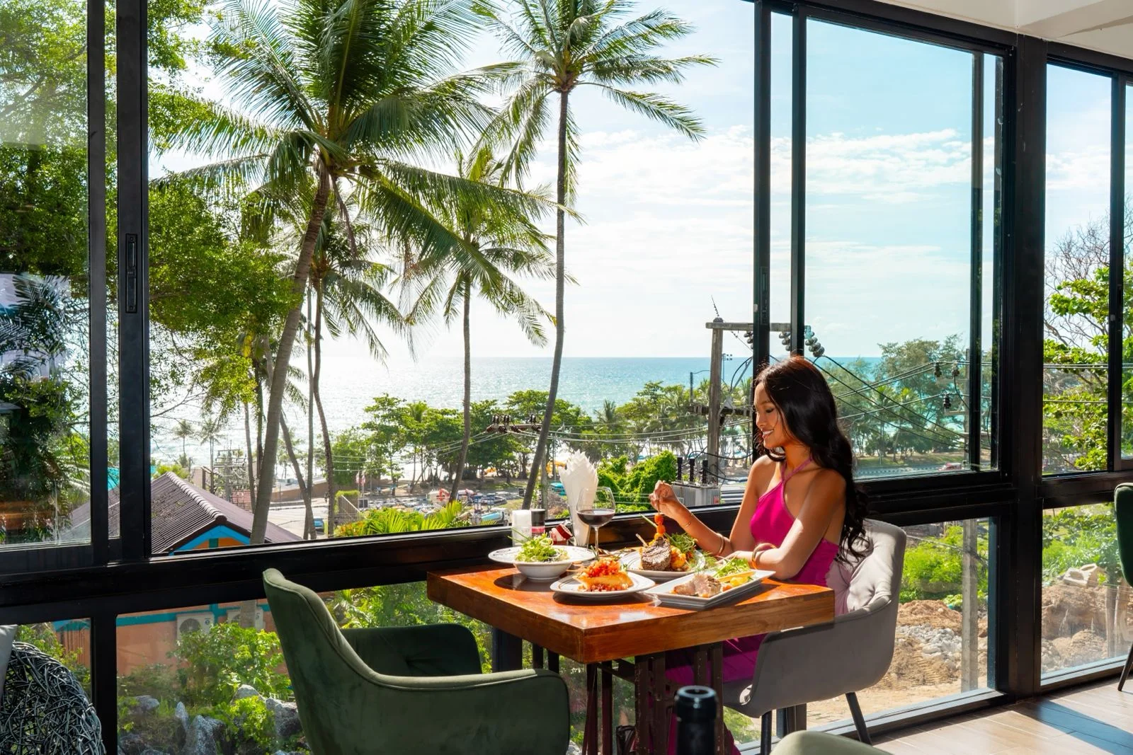 Real guest enjoying dining with a Karon Beach view at EAT Bar & Grill